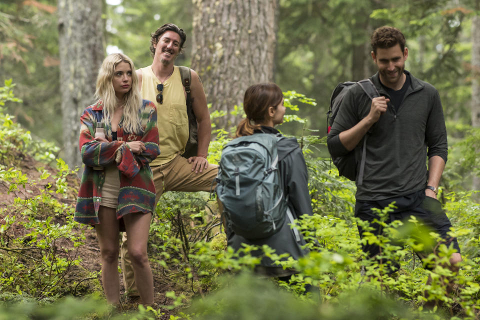 Oliver Jackson-Cohen (on right) as Will during a trek in the forest.