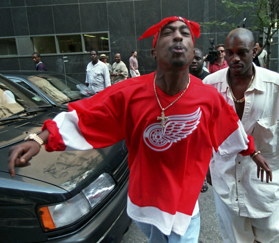 FILE - Rap star Tupac Shakur spits in the direction of reporters as he leaves state Supreme Court in New York, July 5, 1994. Shakur’s shooting in a New York recording studio in the mid-1990s sparked hip-hop’s biggest rivalry and led to the shocking deaths of two of the genre's greatest stars. Shakur and Notorious B.I.G. were gunned down two years later. Nearly three decades later, the recent arrest of longtime suspect Duane “Keffe D” Davis has ignited another wave of intrigue in their unsolved murders. (AP Photo/Bebeto Matthews, File)