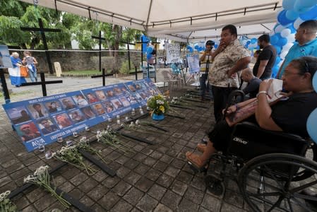 The mother of Reyes looks at an altar during a protest in support of the "Mothers of April" in Managua