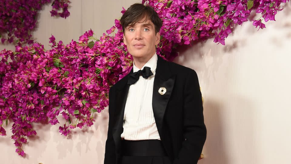 Cillian Murphy wore a custom Atelier Versace suit topped with a gem brooch designed by Hong Kong-based designer Bertrand Mak’s jewelry brand Sauvereign. - Gregg DeGuire/WWD/Getty Images