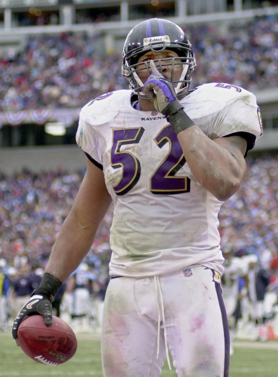 FILE - In this Jan. 7, 2001, file photo, Baltimore Ravens linebacker Ray Lewis celebrates his fourth-quarter interception and touchdown against the Tennessee Titans in the AFC playoff game in Nashville. The Titans playing the Ravens in the divisional round Saturday, Jan. 11, 2020, has revived strong memories of a very intense and bitter playoff rivalry along with the agony of possible Super Bowl titles lost. (AP Photo/Mark Humphrey, File)