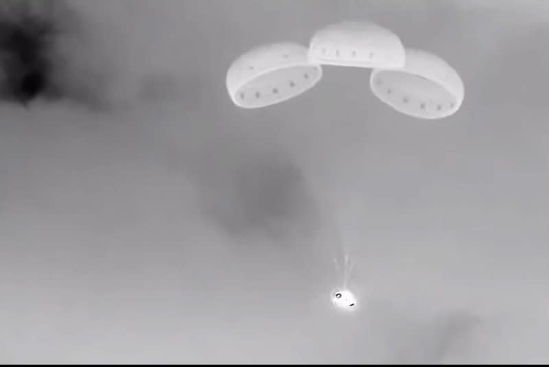 Boeing's Starliner spacecraft descends under parachutes toward its landing site in New Mexico during its return to Earth on Friday night. Photo by NASA/UPI