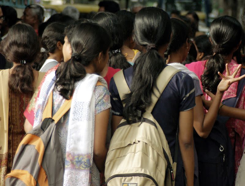 FILE PHOTO: Women stand at a crowded place in the Indian city of Bangalore