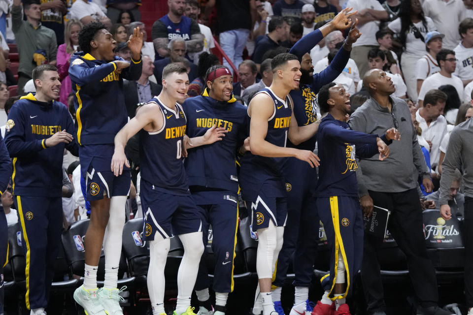 The Denver Nuggets celebrate during the second half of Game 4 of the basketball NBA Finals against the Miami Heat, Friday, June 9, 2023, in Miami. The Nuggets defeated the Heat 108-95. (AP Photo/Wilfredo Lee)