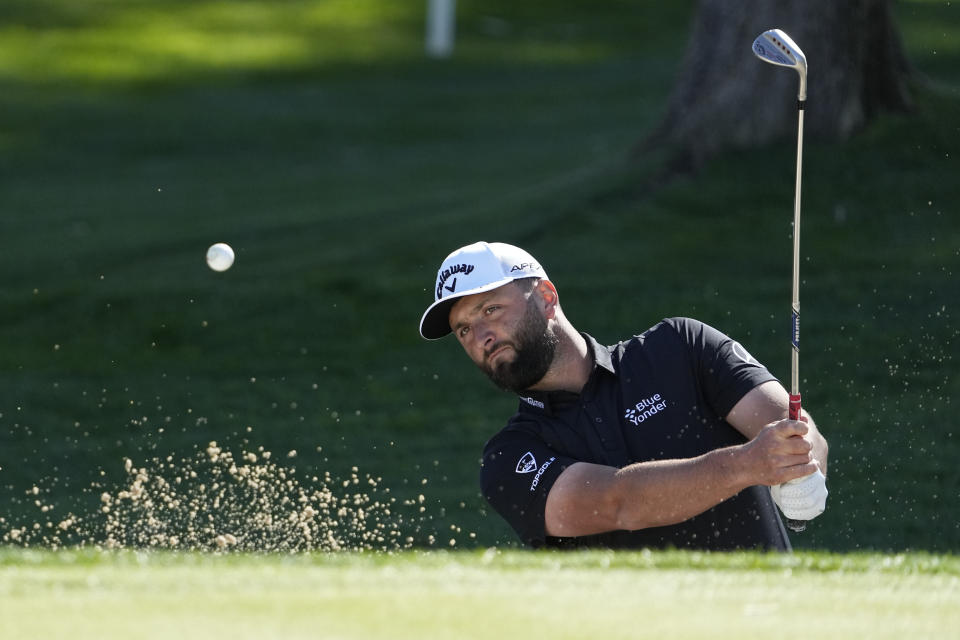 Jon Rahm hits out of a bunker on the fifth hole during the American Express golf tournament on the La Quinta Country Club Course Thursday, Jan. 19, 2023, in La Quinta, Calif. (AP Photo/Mark J. Terrill)