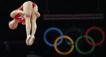 Canada's Rosannagh Maclennan performs during the qualifying round of the women's trampoline at the 2012 Summer Olympics, Saturday, Aug. 4, 2012, in London. (AP Photo/Gregory Bull)