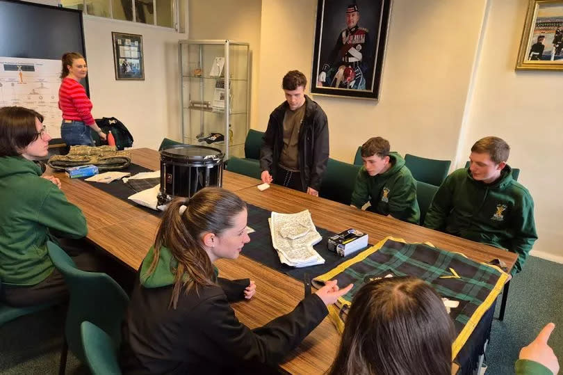 The young people examine objects from the regiment's collection -Credit:Newmains Army Cadets