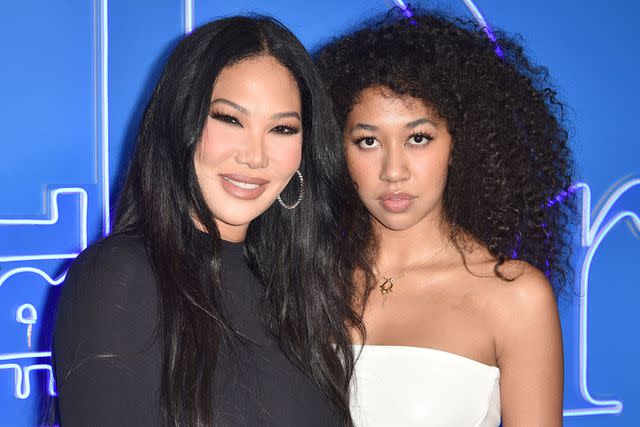 <p>David Crotty/Patrick McMullan via Getty</p> Kimora Lee Simmons and Aoki Lee Simmons attend the DIOR Men's Spring 2023 Fashion Show