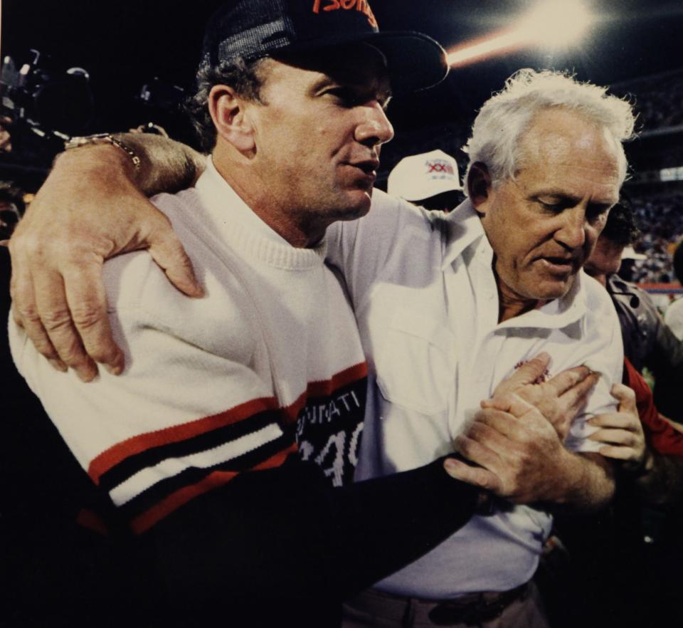 Bengals head coach Sam Wyche, left, and San Francisco head coach Bill Walsh embrace after the 49ers won in the final seconds of Super Bowl 23 in Miami, Jan. 22, 1989.