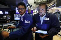 Specialist Christopher Riggs, left, and trader Michael Milano work on the floor of the New York Stock Exchange, Specialist Christopher Riggs, left, and trader Michael Milano work Friday, Aug. 16, 2019. Stocks are opening broadly higher at the end of a turbulent week. (AP Photo/Richard Drew)