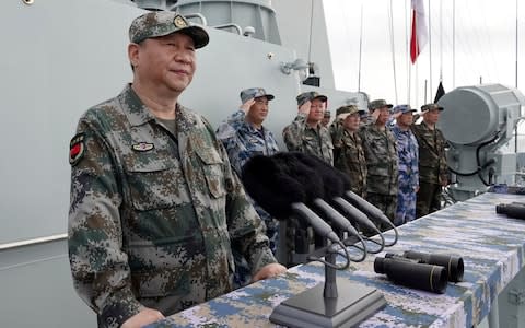 Chinese President Xi Jinping, left, speaks after he reviewed the Chinese fleet in the South China Sea - Credit: Li Gang/Xinhua via AP