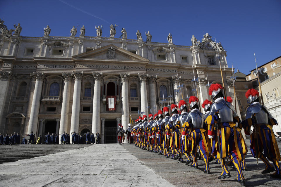 Swiss Guards march in front of Peter's Basilica at the Vatican, Tuesday, Dec. 25, 2018. Monday's late night Mass was the first major event of the Christmas season, followed by Francis' noon Urbi et Orbi (To the city and the world) blessing on Christmas day. (AP Photo/Alessandra Tarantino)