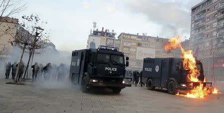 A police vehicle is set on fire by protesters during clashes in Pristina, Kosovo January 9, 2016. REUTERS/Agron Beqiri