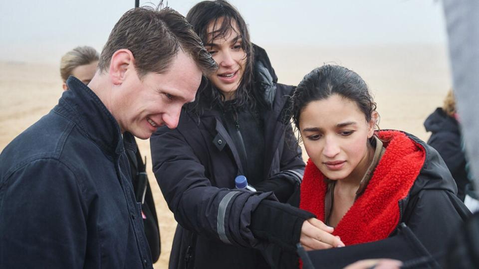 (l-r) Director Tom Harper, Gal Gadot and Alia Bhatt on the set of “Heart of Stone.” (CREDIT: Robert Viglasky/Netflix © 2023)