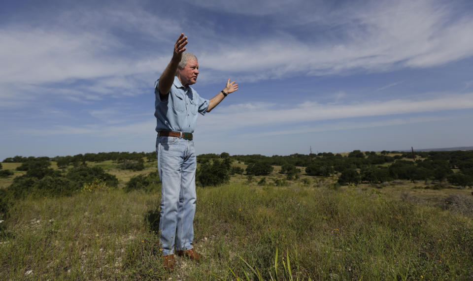 Andy Sansom walks on his property as he talks about a proposed new natural gas pipeline that would pass through his ranch in the Texas Hill Country near Stonewall, Texas Friday, Aug. 2, 2019. A proposed pipeline is a 430-mile, $2 billion natural gas expressway that pipeline giant Kinder Morgan has mapped from the booming West Texas oil patch to Houston. (AP Photo/Eric Gay)