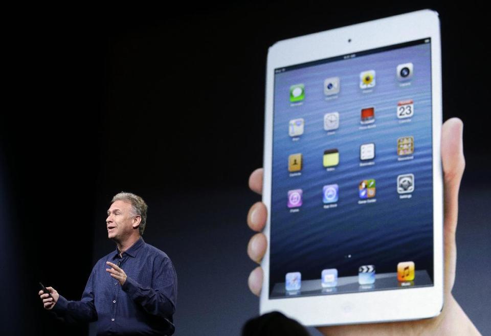 Phil Schiller, Apple's senior vice president of worldwide product marketing, talks in front of a projection of the iPad mini in San Jose, Calif., Tuesday, Oct. 23, 2012. Apple Inc. is refusing to compete on price with its rivals in the tablet market it's pricing its new, smaller iPad well above the competition. On Tuesday, the company revealed the iPad Mini, with a screen that's about two-thirds the size of the full-size model, and said it will cost $329 and up. (AP Photo/Marcio Jose Sanchez)