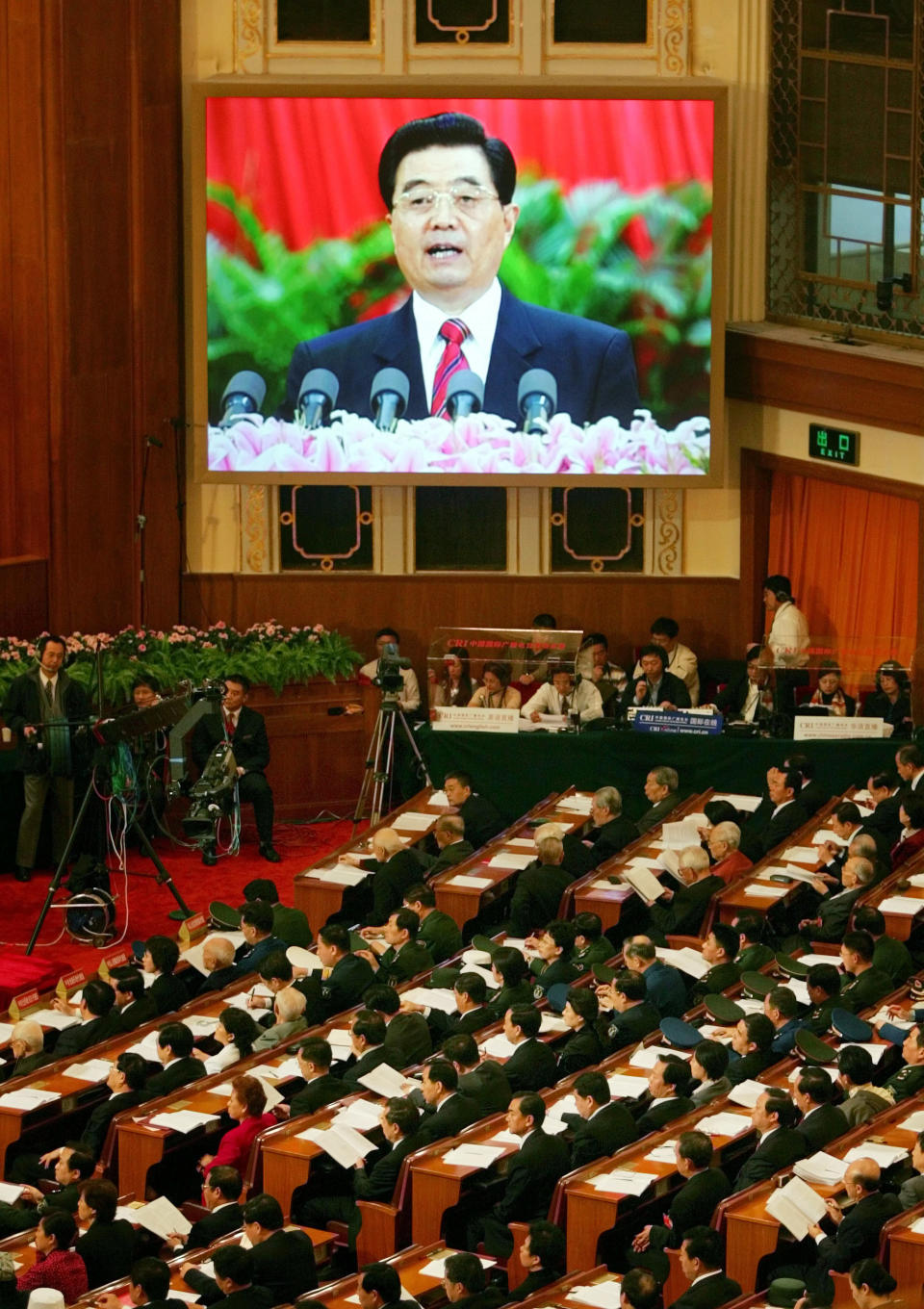 FILE - In this Oct. 15, 2007 file photo, a live image of Chinese leader Hu Jintao is seen on a screen above delegates as he speaks at the opening of the 17th Communist Party Congress in Beijing's Great Hall of the People. As Hu steps down as head of China’s Communist Party after 10 years in power, he’s hearing something unusual for a Chinese leader: sharp criticism. (AP Photo/Greg Baker, File)