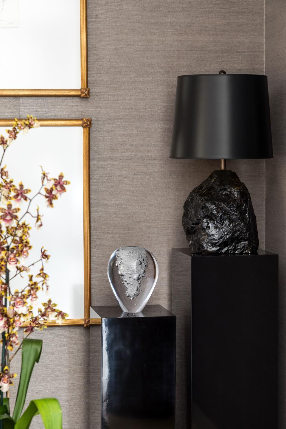 The rock-crystal lamp, sourced from Phoenix Gallery in New York, serves as a counterpoint to the living room’s warmer decor items, adding hard luster to a space that’s layered with plush elements.