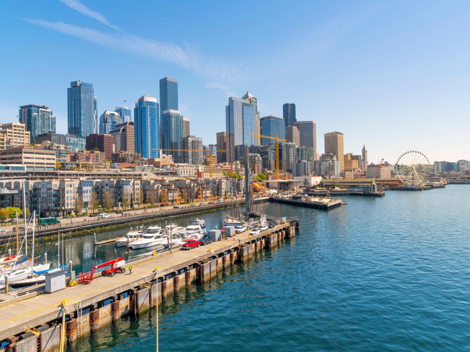 View of the skyline and waterfront harbor tourist area including the Great Wheel from a cruise ship in the Puget Sound in Seattle, Washington.