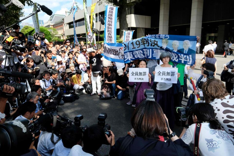 Activists hold banners and placards during a rally in front of the Tokyo District Court. (AFP/Getty Images)