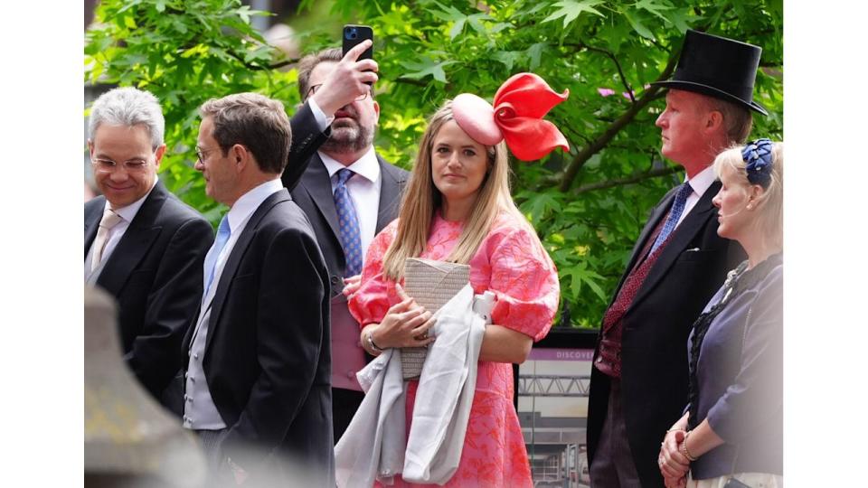 One guest rocking a fabulously overstated fascinator and puffed sleeves