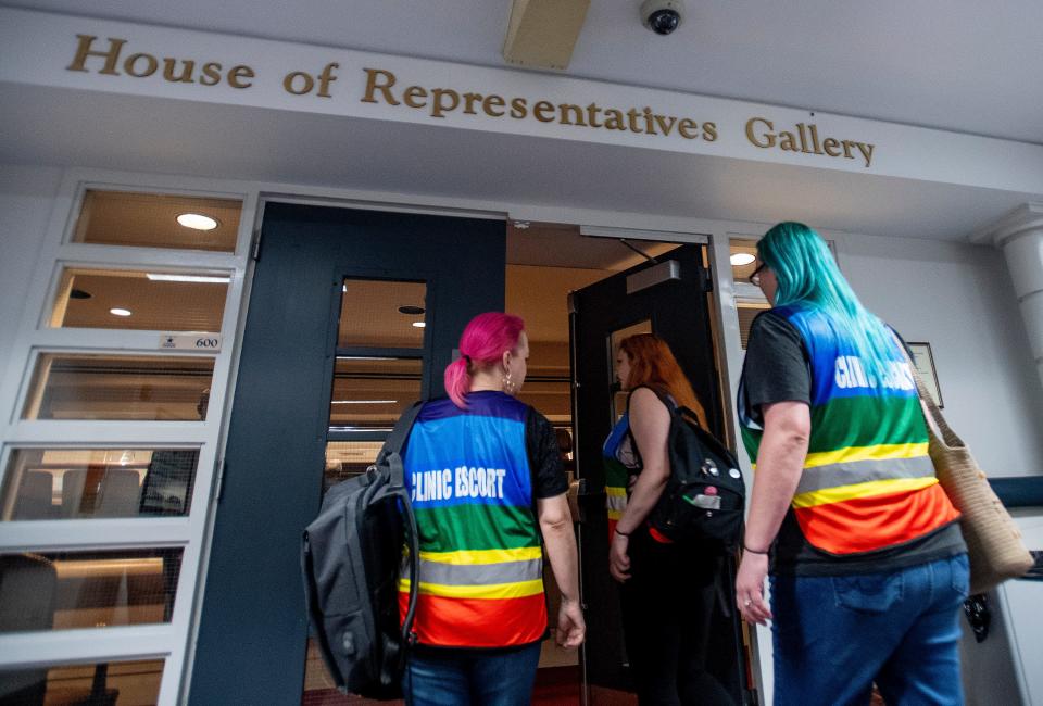 Clinic escorts Mia Raven, from left, Margeaux Hartline and Kari Crowe walk into the gallery to watch debate on the abortion ban bill at the Alabama Statehouse in Montgomery, Ala., on Tuesday April 30, 2019.