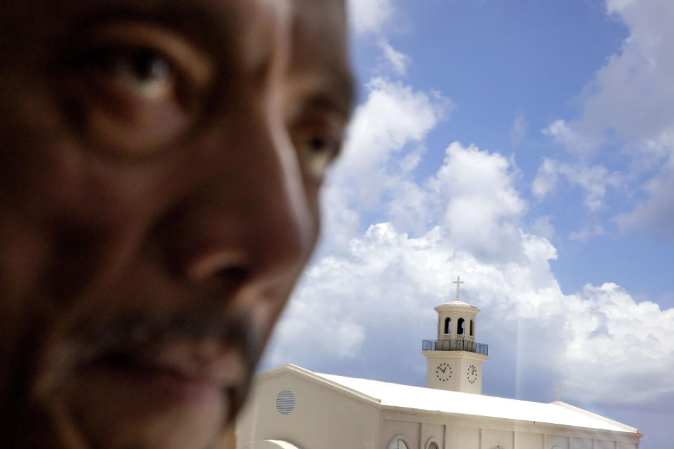 B.J. Cruz, a former vice speaker of the Guamanian Senate, is photographed in his office which overlooks the island's main cathedral, Dulce Nombre de Maria Cathedral-Basilica, in Hagatna, Guam, Tuesday, May 7, 2019. A clergy sexual assault survivor himself, Cruz introduced a bill in 2010 to lift the statute of limitations on child sex abuse lawsuits, opening a two-year window to seek compensation. (AP Photo/David Goldman)