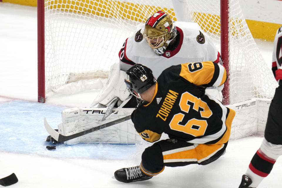 Ottawa Senators goaltender Joonas Korpisalo (70) blocks a shot by Pittsburgh Penguins Radim Zohorna (63) during the first period of an NHL hockey game in Pittsburgh, Saturday, Oct. 28, 2023. (AP Photo/Gene J. Puskar)