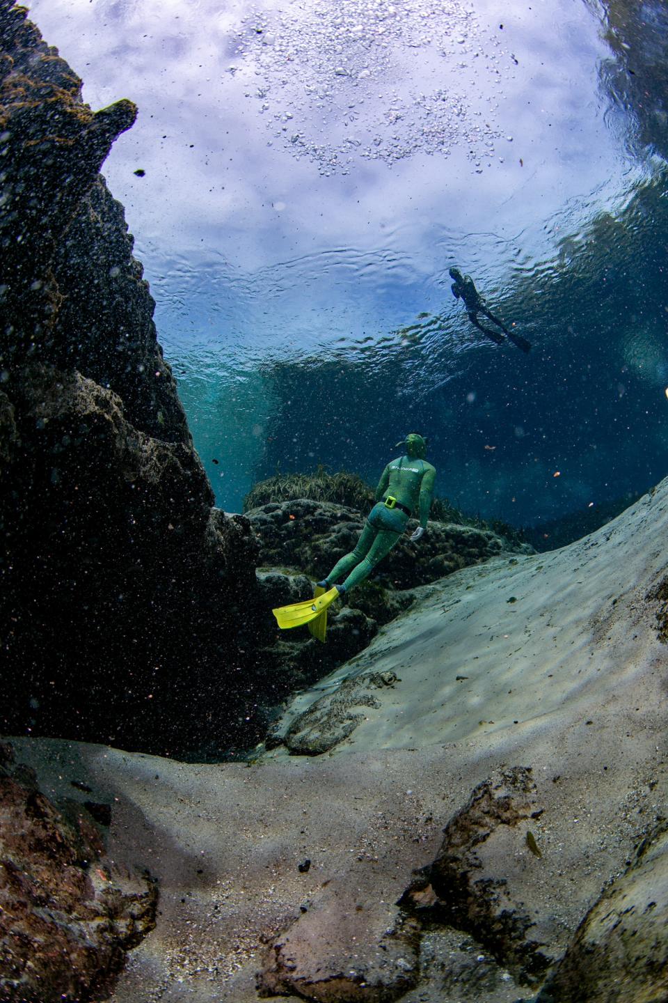 Free divers make a descent into the main spring at Alexander Springs recreation area in Altoona Florida on Thursday, October 14, 2021. The eel grass is covered with a variety of algae. The spring is open to scuba diving and swimming. Alexander Springs is part of the Florida Wildlife Corridor which includes 17.7 million acres of land across Florida that residents are encouraged to explore and conserve. About 43% of Marion County is included in the corridor, including the Ocala National Forest and many area springs.