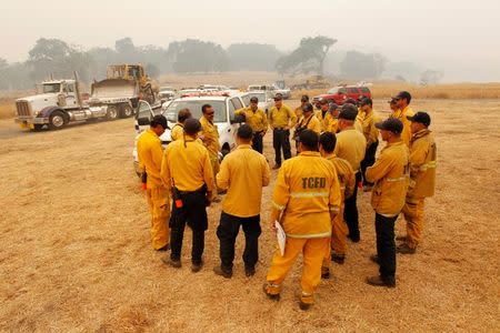 Tulare County firefighters are briefed before setting off to fight the Soberanes Fire off of Rancho San Carlos Road near Carmel Valley, California, U.S. July 29, 2016. REUTERS/Michael Fiala