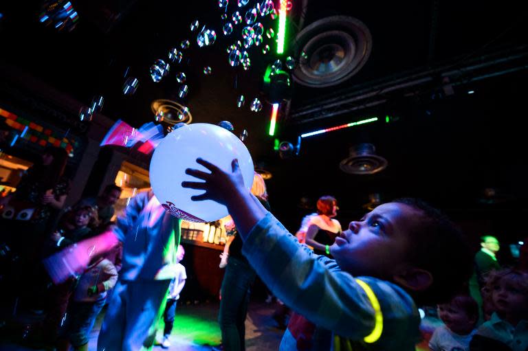 Two-year-old Oscar enjoys the music and entertainment at the Big Fish Little Fish "2-4 Hour Party People" event in Brixton, South London, on April 12, 2014