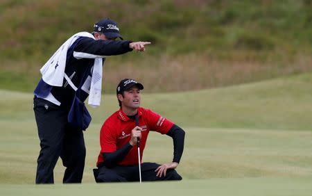 Robert Streb of the U.S.lines up a putt with his caddie on the 17th green during the first round of the British Open golf championship on the Old Course in St. Andrews, Scotland, July 16, 2015. REUTERS/Russell Cheyne . Picture Supplied by Action Images