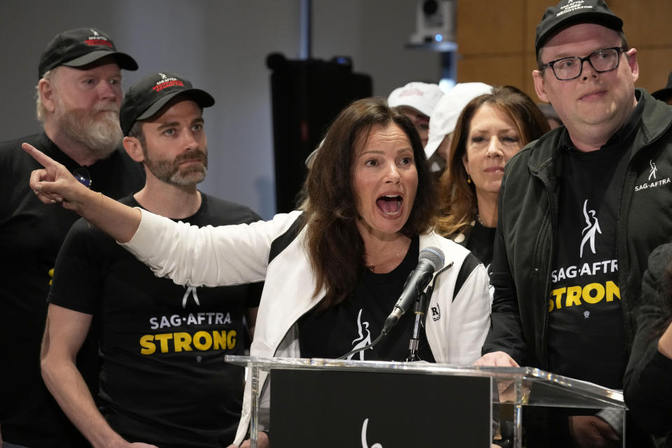 FILE - SAG-AFTRA president Fran Drescher, center, and SAG-AFTRA National Executive Director and Chief Negotiator Duncan Crabtree-Ireland speak during a press conference announcing a strike by The Screen Actors Guild-American Federation of Television and Radio Artists on Thursday, July, 13, 2023, in Los Angeles. Saturday marks the 100th day that film and TV performers from the Screen Actors Guild-American Federation of Television and Radio Artists have been on strike, seeking changes to compensation and protections from use of artificial intelligence in their craft. Imax CEO Rich Gelfond said the actors' strike will lead to 'some movement' in 2024 release dates (AP Photo/Chris Pizzello, File)