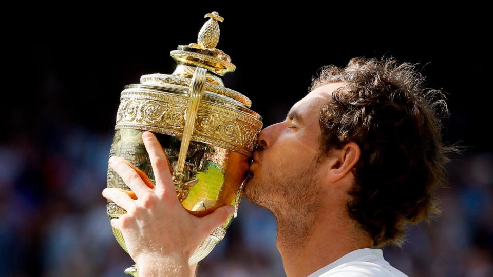 PHOTO: Andy Murray of Britain kisses his trophy after beating Milos Raonic of Canada in the men's singles final on day fourteen of the Wimbledon Tennis Championships in London, July 10, 2016. (Ben Curtis/AP, FILE)