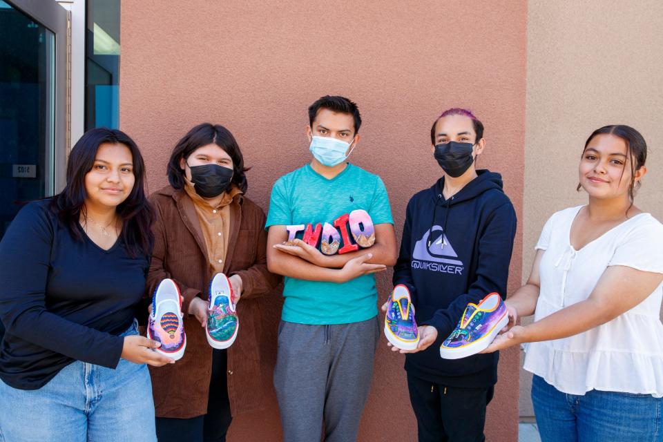 Indio High School students Marlene Arriaga, left, Alexa Lerma-Diaz, Jose Ortiz-Patraca, Victor Mariscal, and Betsabe Soria pose for a photograph with their designed and painted blank Vans at the school in Indio, Calif., on Wednesday, April 27, 2022. The custom designs were for the Vans High School Custom Culture competition with the theme of Hometown Pride. 