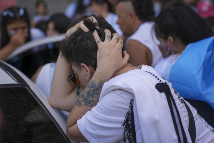 Argentine soccer fans react to France scoring a goal during the World Cup final soccer match between Argentina and France in Buenos Aires, Argentina, Sunday, Dec. 18, 2022. (AP Photo/Matilde Campodonico)