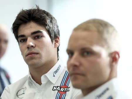 The newly announced Williams Martini Racing driver for the 2017 season Lance Stroll (L) and team-mate Valteri Bottas attend a media conference at their base in Wantage, Britain November 3, 2016. REUTERS/Eddie Keogh