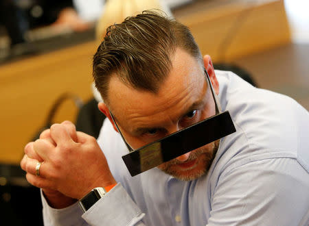 FILE PHOTO: Lutz Bachmann, co-founder of Patriotic Europeans Against the Islamisation of the West (PEGIDA), waits in a courtroom for his trial to be charged with incitement over Facebook posts in a court in Dresden, Germany, April 19, 2016. REUTERS/Fabrizio Bensch/File Photo