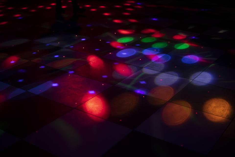 Light music in bar. Disco in studio. Lights on floor. Lighting equipment for show.