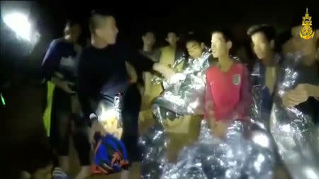 Boys from the under-16 soccer team trapped inside Tham Luang cave greet members of the Thai rescue team in Chiang Rai, Thailand, in this still image taken from a July 3, 2018 video by Thai Navy Seal. Thai Navy Seal/Handout via REUTERS TV