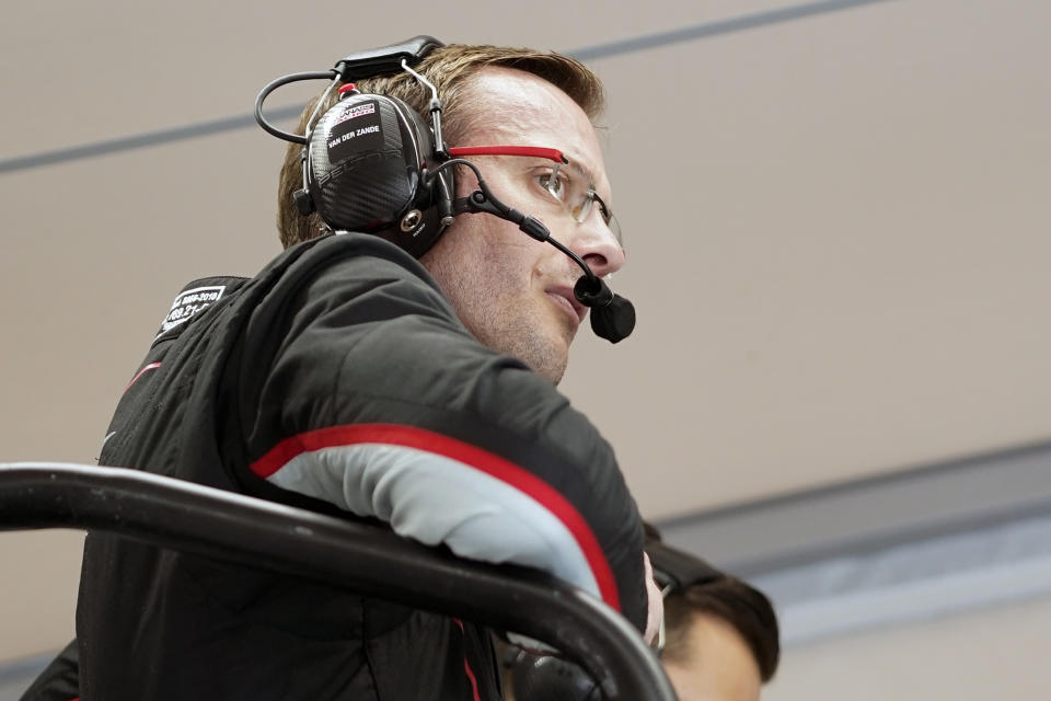 Sebastian Bourdais, of France, watches teammates practice from his pit stall during a practice session for the Rolex 24 hour auto race at Daytona International Speedway, Friday, Jan. 28, 2022, in Daytona Beach, Fla. (AP Photo/John Raoux)