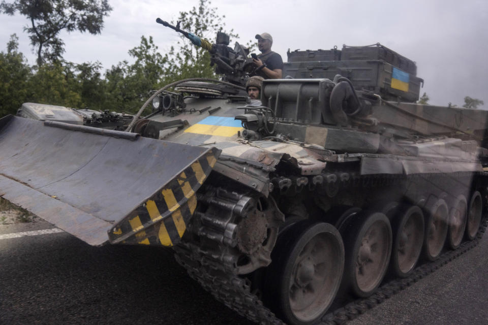 Ukrainian soldiers ride a tank on a road, in Stupochky, Donetsk region, eastern Ukraine, Sunday, July 10, 2022. (AP Photo/Nariman El-Mofty)