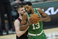 Boston Celtics' Tristan Thompson, right, drives against Cleveland Cavaliers' Dean Wade during the first half of an NBA basketball game Wednesday, May 12, 2021, in Cleveland. (AP Photo/Tony Dejak)