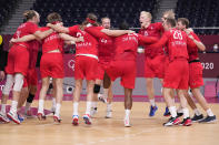 Denmark's team players celebrate as they won the men's semifinal handball match between Spain and Denmark at the 2020 Summer Olympics, Thursday, Aug. 5, 2021, in Tokyo, Japan. (AP Photo/Pavel Golovkin)