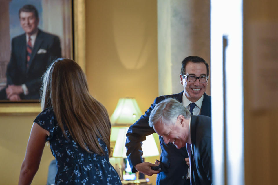 Treasury Secretary Steven Mnuchin, right, and White House Chief of Staff Mark Meadows, second from right, sit down in the office of Senate Majority Leader Mitch McConnell of Ky., on Capitol Hill in Washington, Monday, Aug. 3, 2020. Mnunchin and Meadows were coming from a meeting with House Speaker Nancy Pelosi of Calif., and Senate Minority Leader Sen. Chuck Schumer of N.Y., to continue their negotiations on a coronavirus relief package. (AP Photo/Susan Walsh)