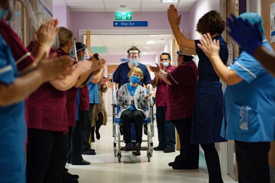 Margaret Keenan, 90, is applauded by staff as she returns to her ward after becoming the first person in the United Kingdom to receive the Pfizer/BioNtech COVID-19 vaccine at University Hospital on December 8, 2020 in Coventry, United Kingdom. 