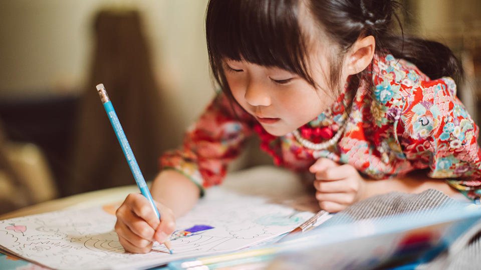 A young girl draws as an example of how kids can deal with coronavirus