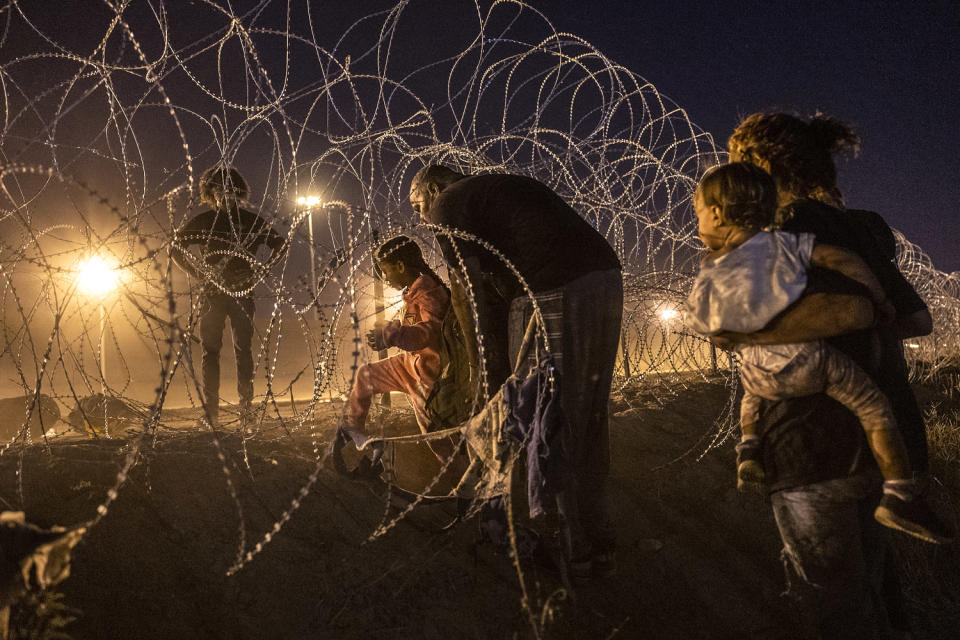 Immigrant families cross into the United States from Mexico to seek asylum (John Moore / Getty Images file)