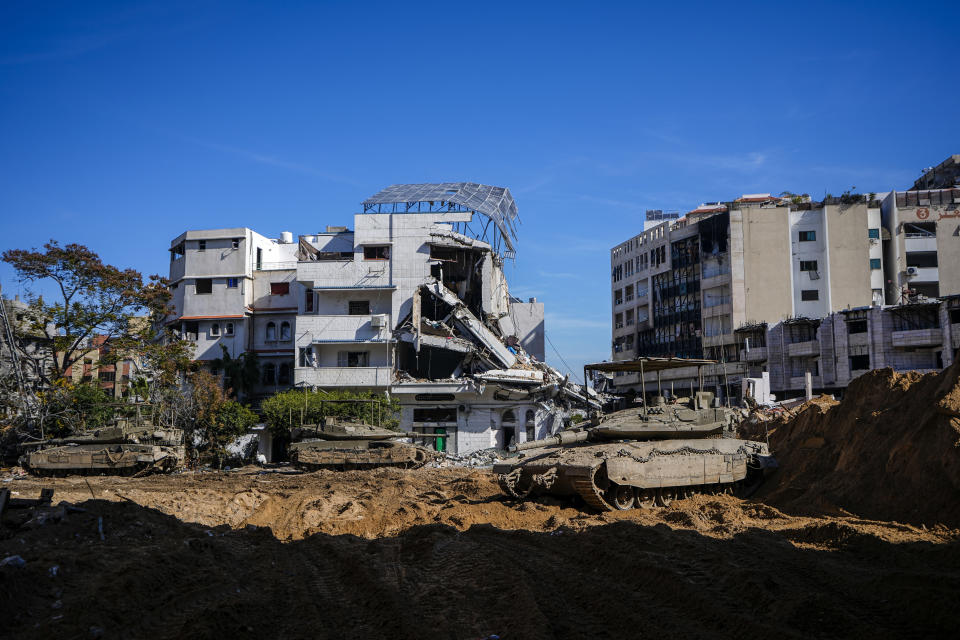 Israeli tanks parked next to UNRWA compound where the military discovered tunnels underneath the main headquarters of the U.N. agency that the military says Hamas militants used to attack its forces during a ground operation in Gaza, Thursday, Feb. 8, 2024. The Israeli military says it has discovered tunnels underneath the main headquarters of the U.N. agency for Palestinian refugees in Gaza City, alleging that Hamas militants used the space as an electrical supply room. The unveiling of the tunnels marked the latest chapter in Israel's campaign against the embattled agency, which it accuses of collaborating with Hamas. (AP Photo/Ariel Schalit)