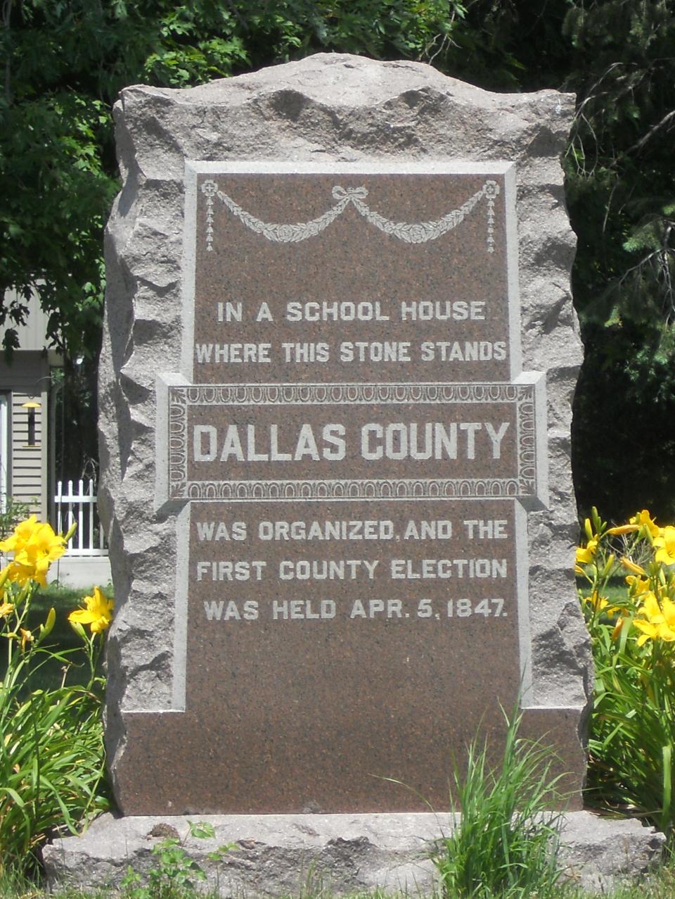 A granite marker recognizes the first schoolhouse built in Dallas County. The log cabin was built in Adel Township during the winter of 1847-1848.
